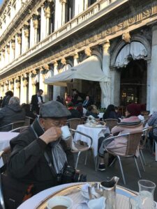 A customer in front of the Florian Cafe in Venice, Italy