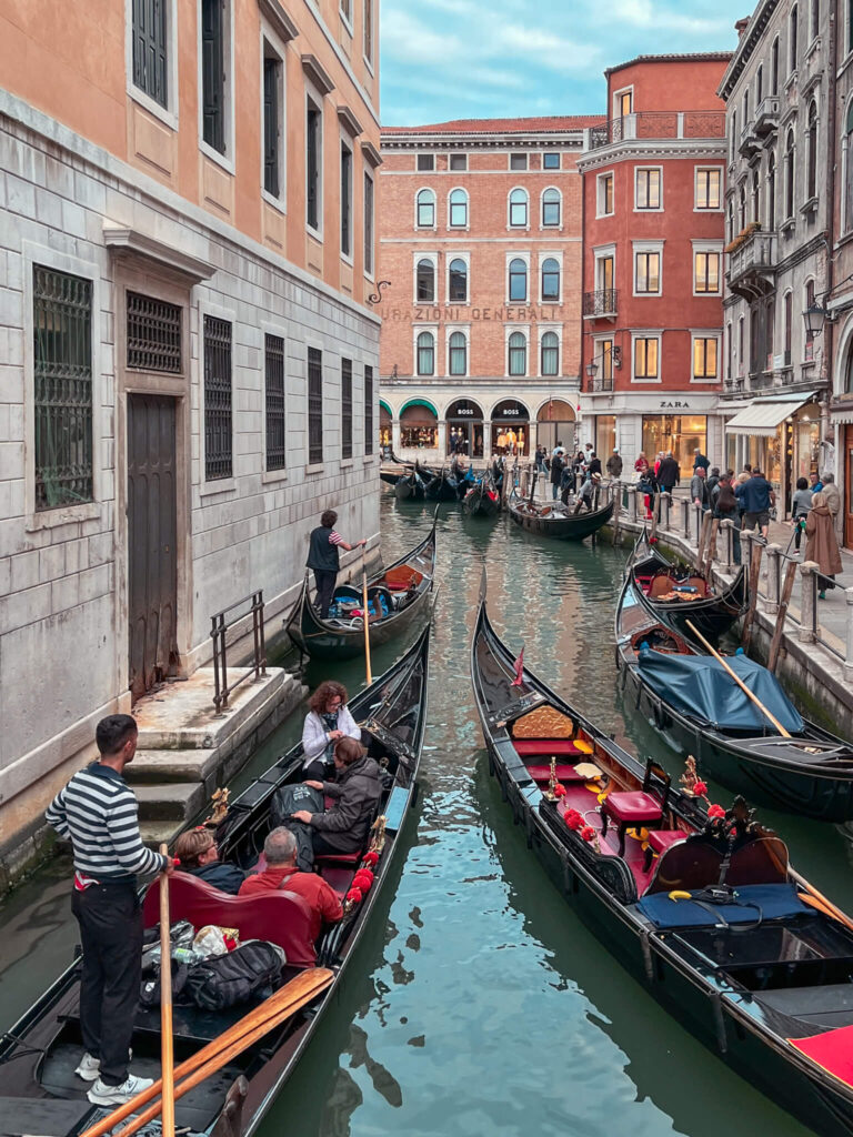Gondolas in a Venice canal, a featured image for Ultimate Packing Venice list: what to pack for Venice, part of a Venice travel guide series